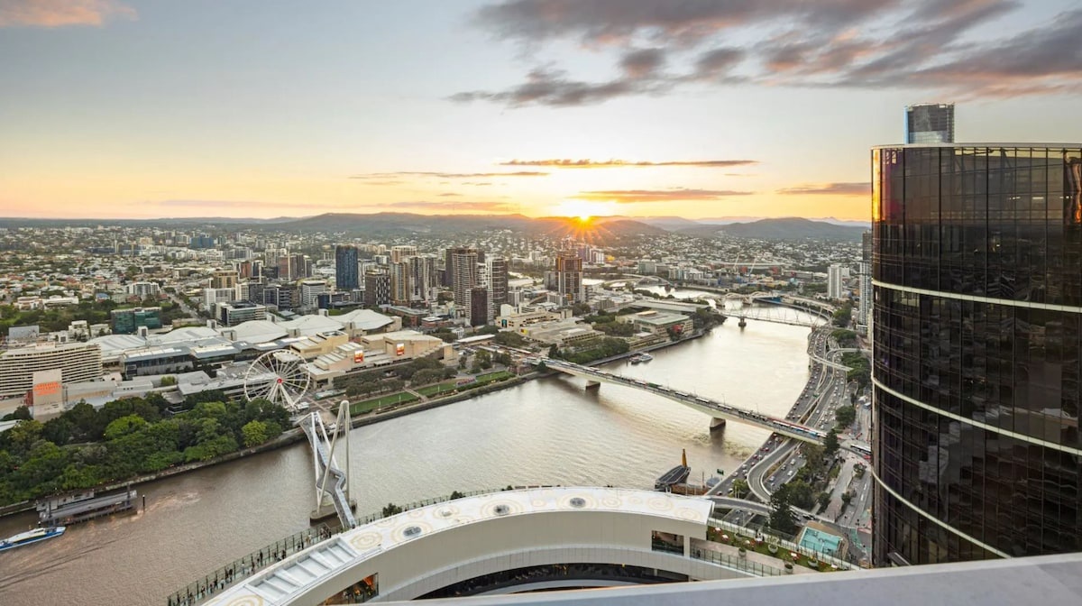 Luxury penthouse with Brisbane city skyline at golden hour